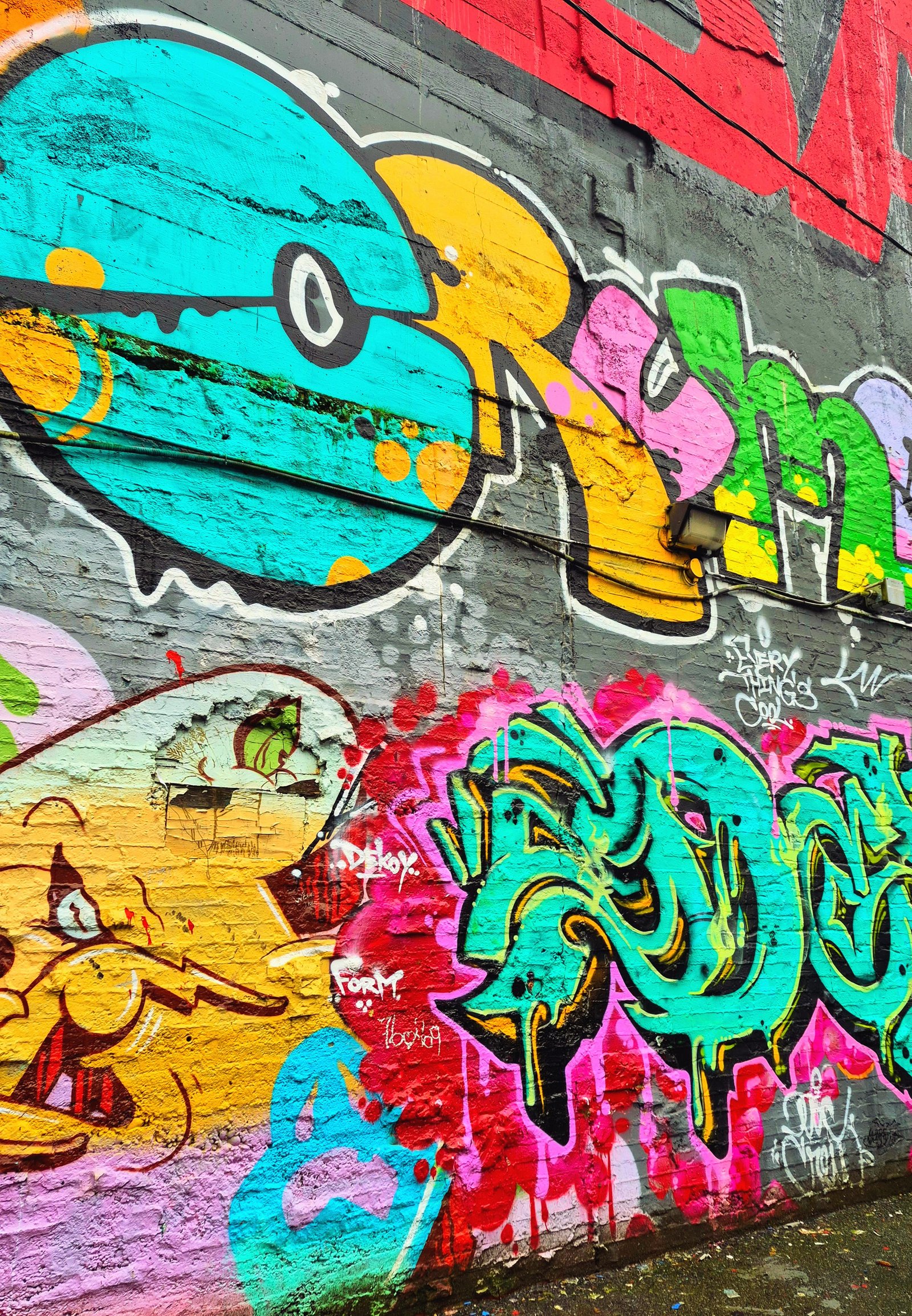 Colourful graffiti wall reading Every Thing's Cool